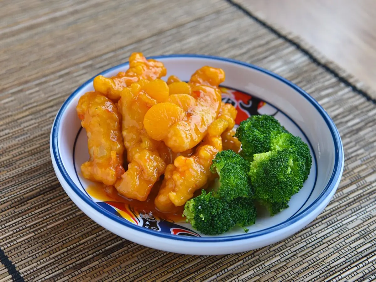 weet and Sour Chicken is tender chicken strips coated in a crispy batter, glazed with a tangy - sweet sauce at Dragon City, a Chinese restaurant in Albany